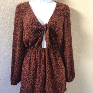 Long sleeve floral dark brown romper.